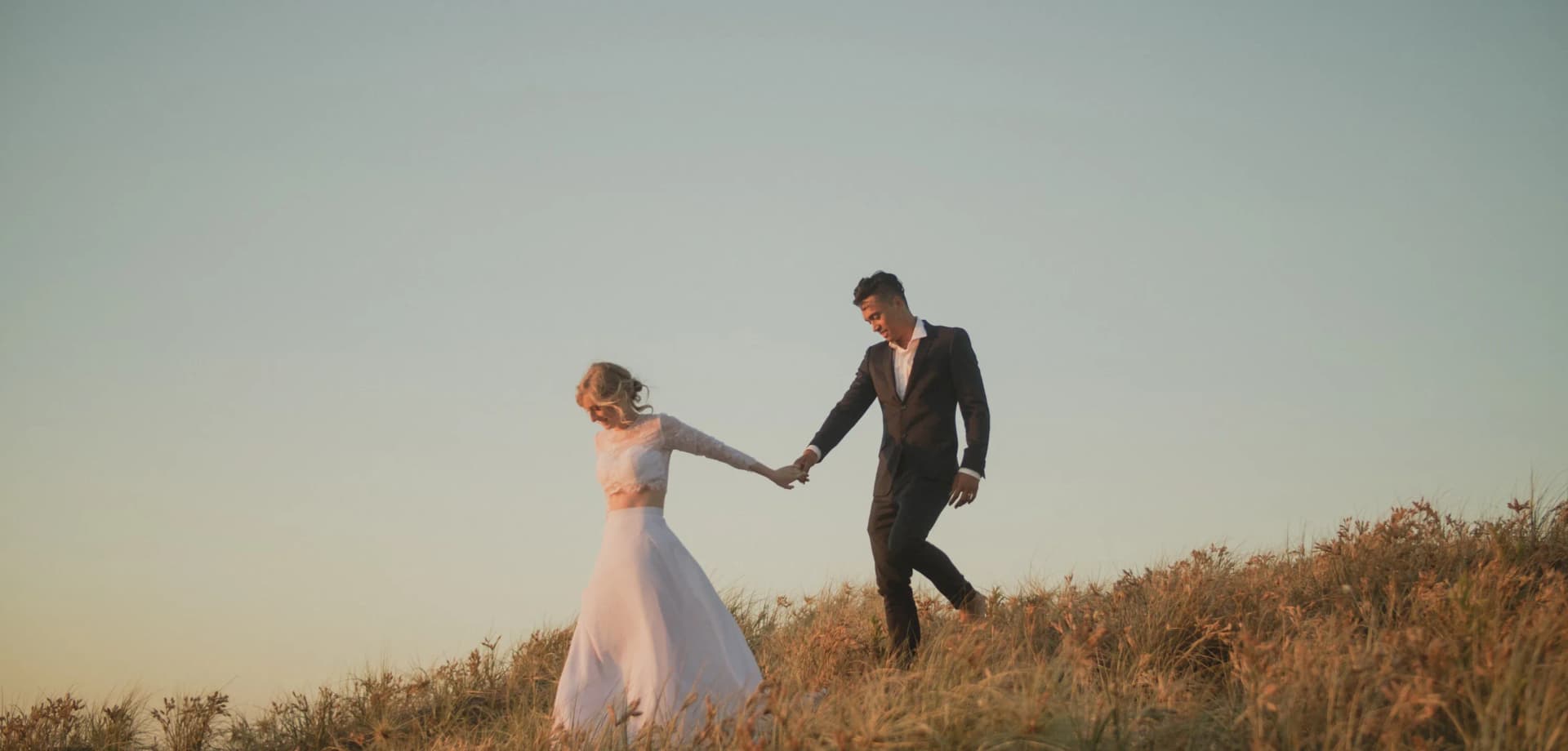 David and Naomi walk along the Whanganui coastline