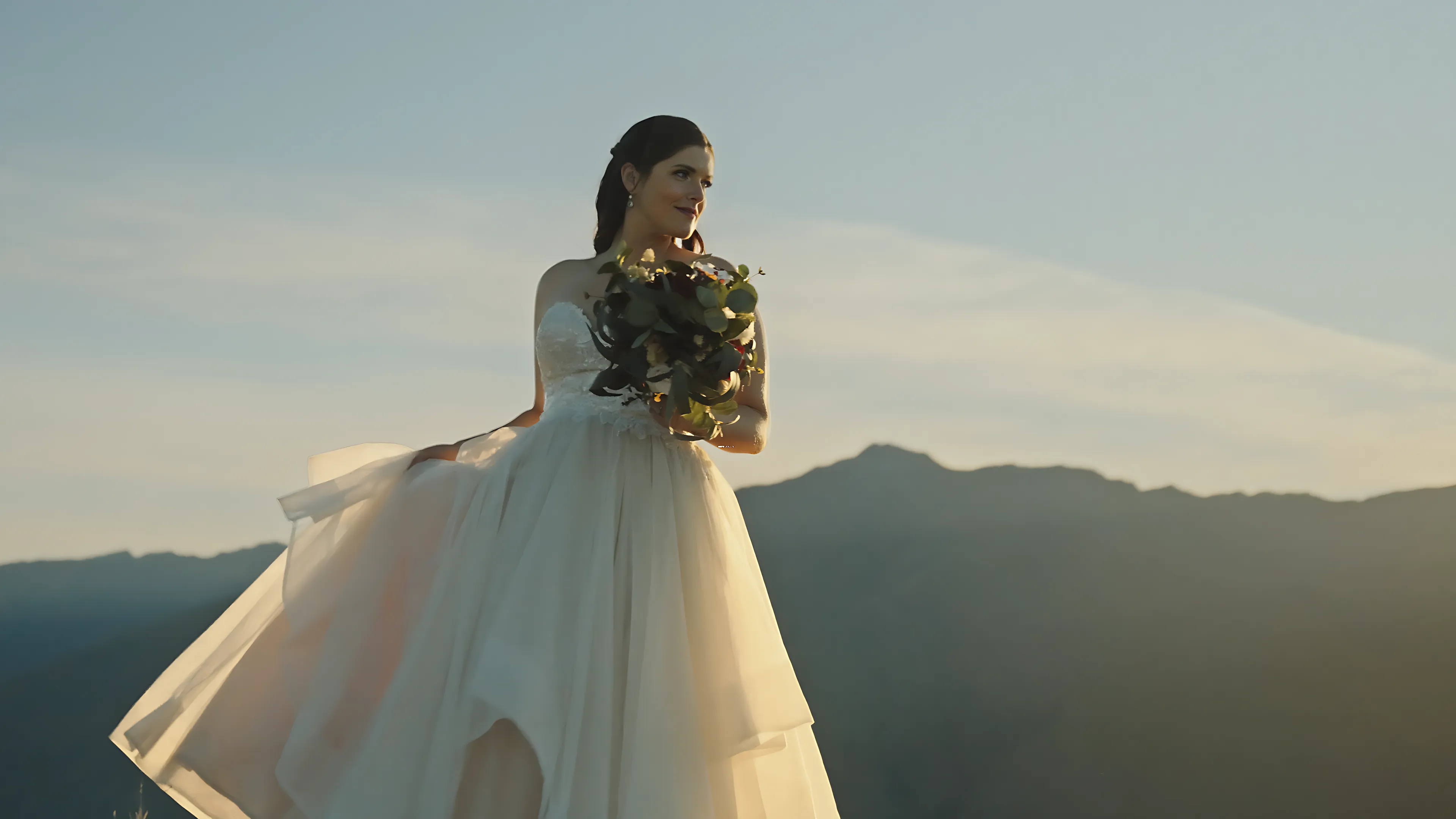 Kristel twirling in her gown on the mountain