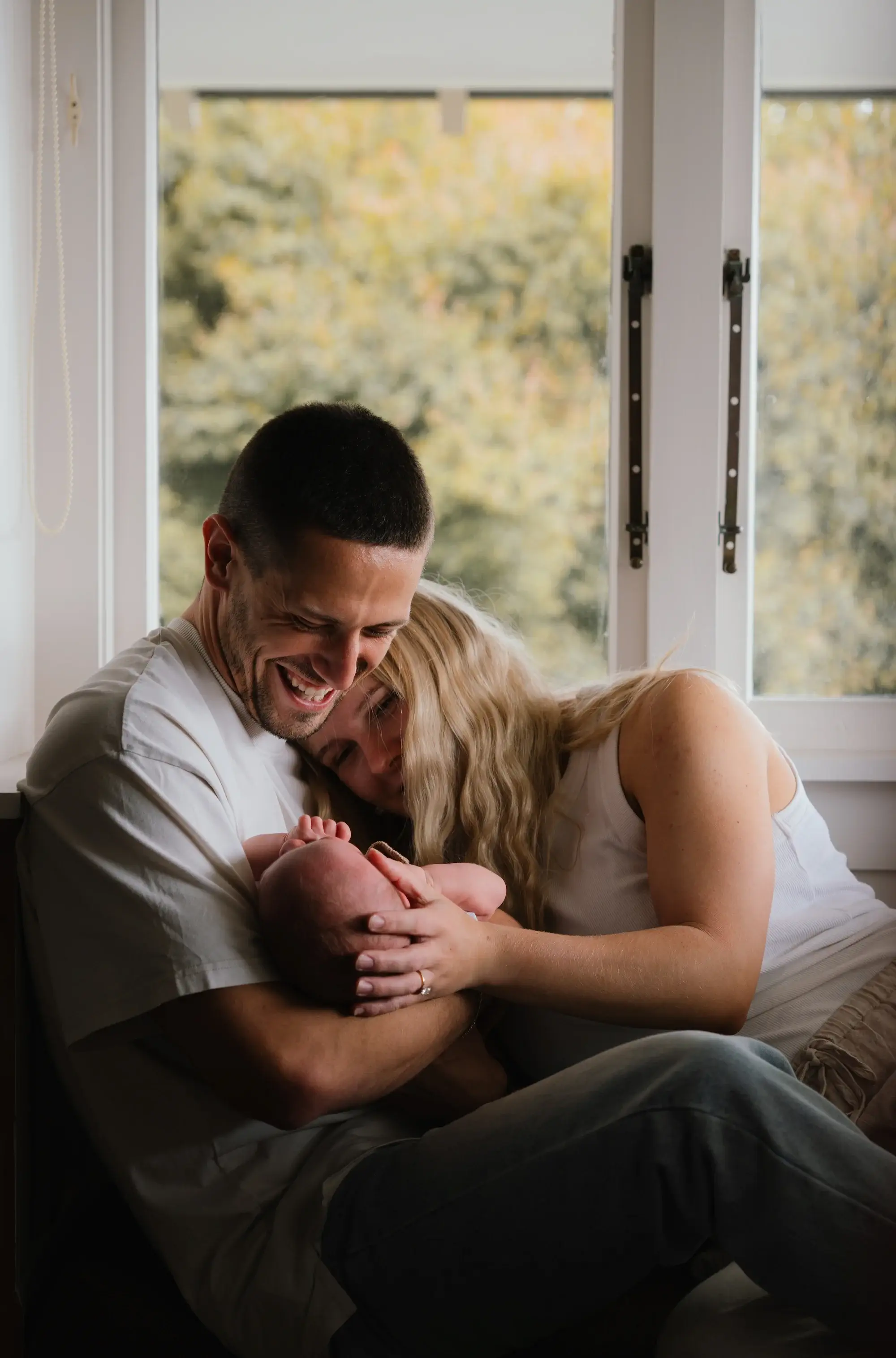 Newborn photography New Plymouth - baby swaddled while resting on a linen throw